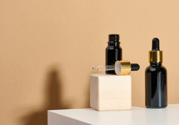 brown glass bottle with pipette stands on a white 2026 01 09 07 00 17 utc