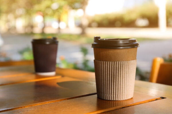 cardboard coffee cup on wooden table outdoors spa 2026 03 05 11 54 03 utc (1)