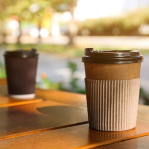 cardboard coffee cup on wooden table outdoors spa 2026 03 05 11 54 03 utc