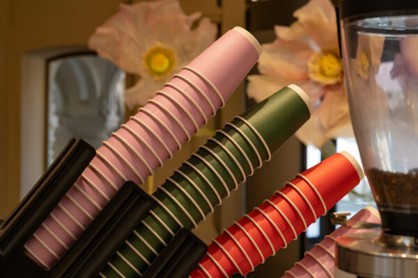 colorful disposable coffee cups stacked in holder 2026 01 11 10 12 01 utc
