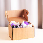 open cardboard beauty box with body care and skin 2026 03 09 03 24 19 utc