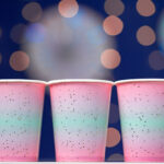 pink disposable cups on blue bokeh background 2026 01 09 06 37 38 utc
