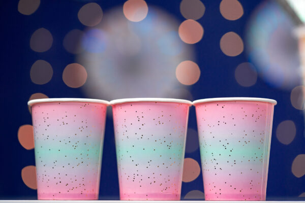 pink disposable cups on blue bokeh background 2026 01 09 06 37 38 utc