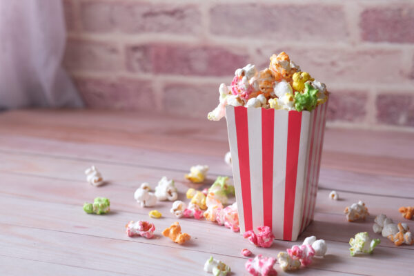 popcorn spilling from a paper container on wooden 2026 01 07 01 25 45 utc