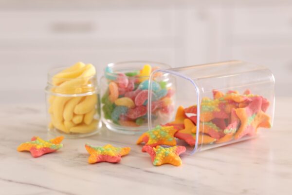 tasty gummy candies in glass jars on white marble 2026 01 11 11 08 32 utc