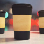 three black paper coffee cup on a table in a cafe 2026 01 11 08 48 16 utc