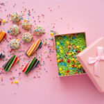top view of colorful sweets near gift box with spr 2026 01 11 10 47 08 utc