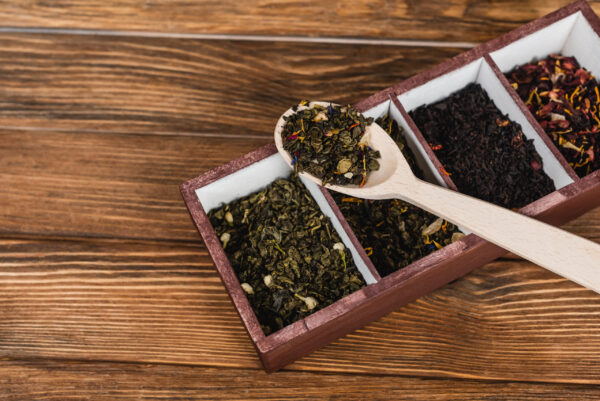 top view of dry tea on spoon and box on wooden sur 2026 01 06 00 17 33 utc