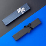 two long jewelry boxes on black and blue backgroun 2026 03 19 02 22 12 utc