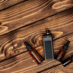 vape and vape juice bottles on brown wooden backgr 2026 01 08 07 11 31 utc
