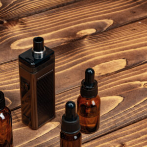 vape and vape juice bottles on brown wooden backgr 2026 01 08 22 41 08 utc