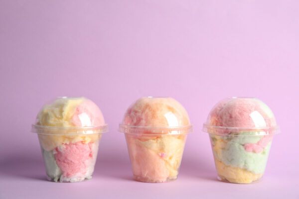 yummy cotton candy in plastic cups on color backgr 2026 03 01 20 33 26 utc