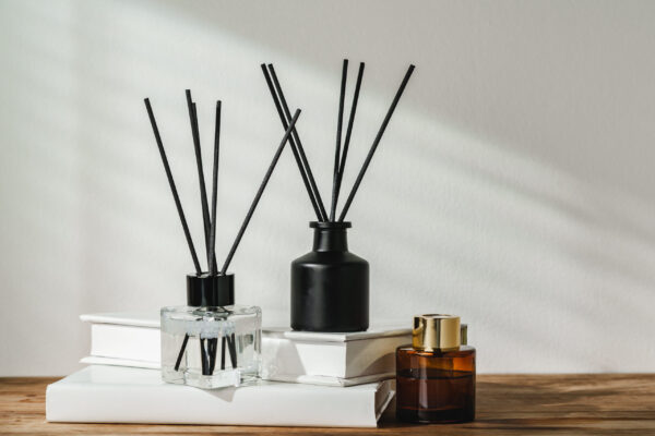 aromatic reed diffuser on white books with shadows 2026 03 24 12 58 01 utc