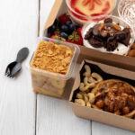 assortment of desserts in boxes on white wooden ba 2026 01 09 06 35 24 utc
