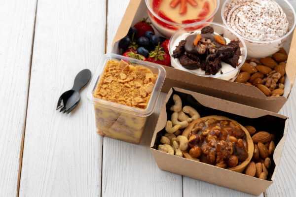 assortment of desserts in boxes on white wooden ba 2026 01 09 06 35 24 utc