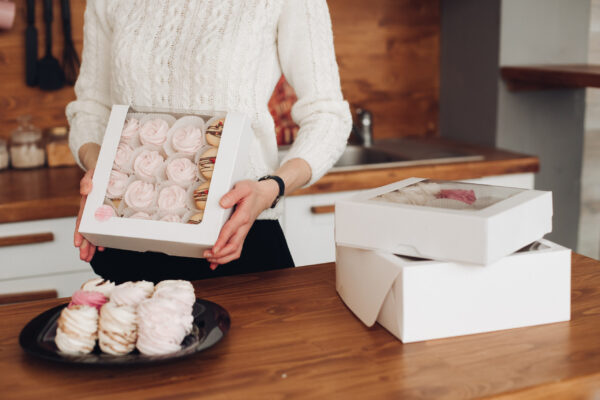 attractive woman holds a box with marshmallows in 2026 03 19 08 20 02 utc