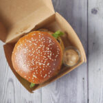 beef burger and french fries in a takeaway paper b 2026 03 17 03 33 00 utc