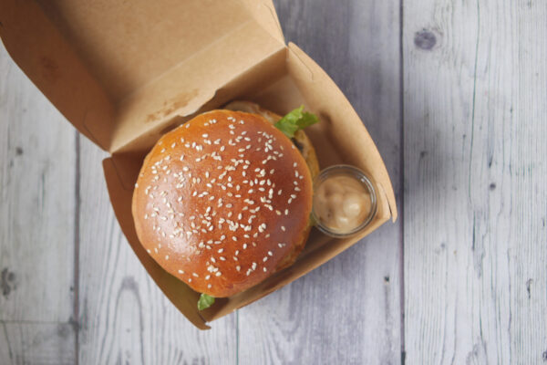 beef burger and french fries in a takeaway paper b 2026 03 17 03 33 00 utc
