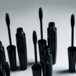 black mascara brushes and containers on gray backg 2026 01 05 05 08 04 utc