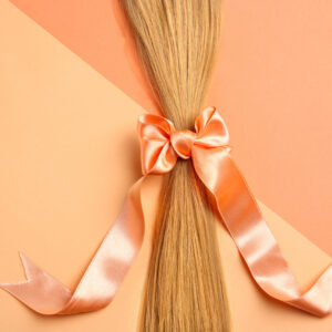 blond hair tied with ribbon on color background t 2026 03 05 11 50 11 utc