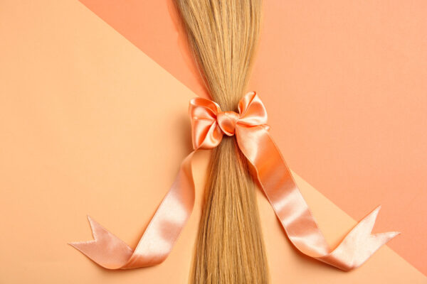 blond hair tied with ribbon on color background t 2026 03 05 11 50 11 utc
