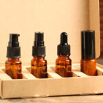 bottles with oil in box on wooden table closeup 2026 03 27 01 38 21 utc