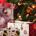 christmas bags with gifts in front of christmas tr 2026 03 20 04 48 04 utc