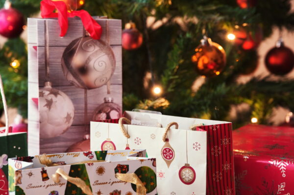 christmas bags with gifts in front of christmas tr 2026 03 20 04 48 04 utc