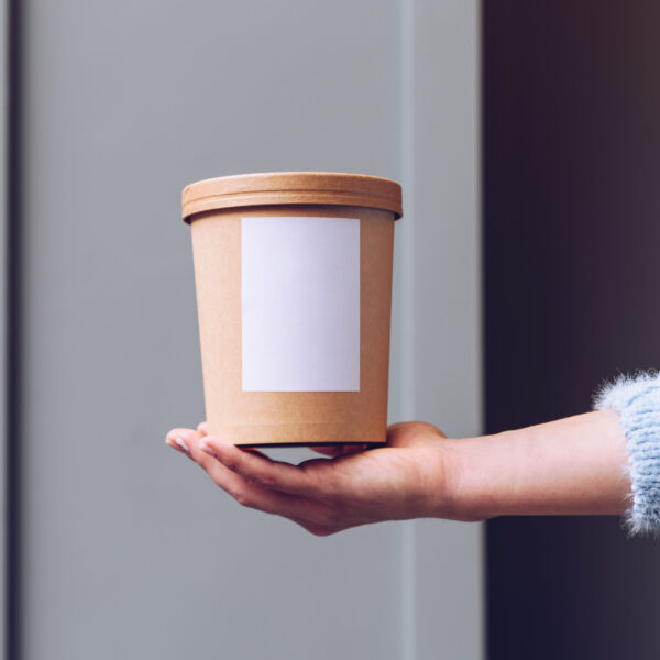 close up female hands holding paper food container 2026 03 17 07 20 34 utc