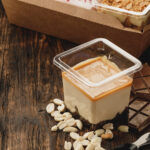 creamy dessert in a plastic box on wooden table 2026 01 08 05 51 21 utc