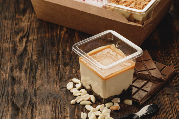 creamy dessert in a plastic box on wooden table 2026 01 08 05 51 21 utc
