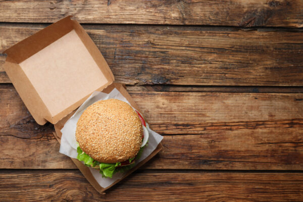 delicious burger in cardboard box on wooden table 2026 01 16 16 55 27 utc