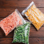 different frozen vegetables on wooden table flat 2026 03 26 23 49 59 utc