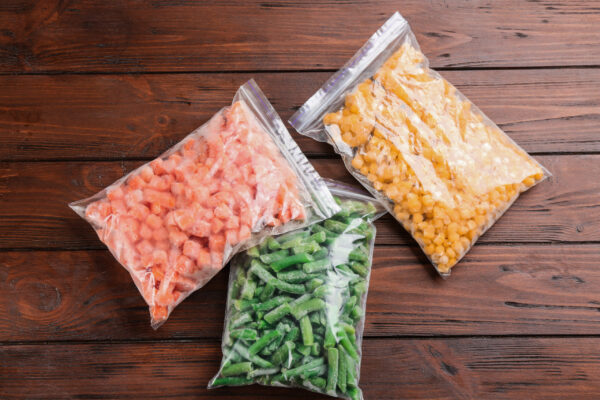 different frozen vegetables on wooden table flat 2026 03 26 23 49 59 utc