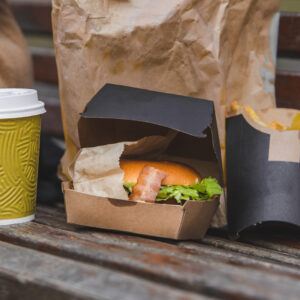 fast food big burger with cup of tea on a bench 2026 03 26 03 58 31 utc
