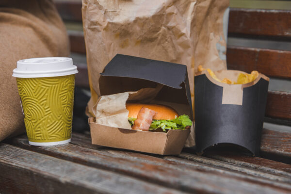 fast food big burger with cup of tea on a bench 2026 03 26 03 58 31 utc