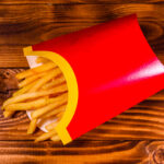 french fries in red box on rustic wooden table to 2026 03 26 03 47 54 utc (1)