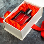 front view of woman perfume on a gift box on red r 2026 01 07 23 39 13 utc