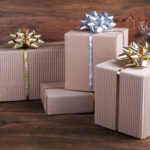 gift boxes with ribbons and bows on wooden backgro 2026 03 15 23 27 07 utc