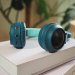 headphones resting on stacked books near a plant 2026 03 25 09 14 17 utc