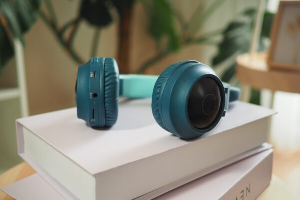 headphones resting on stacked books near a plant 2026 03 25 09 14 17 utc