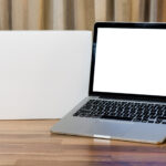 laptop with blank screen on wooden table and blurr 2026 01 05 06 13 28 utc