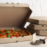 large pizza in open carton box and cutter on kitch 2026 01 08 21 50 21 utc