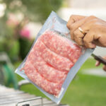 man opens a package of meat to make a barbecue 2026 01 08 06 36 32 utc