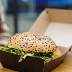 one burger in a box on a table on the terrace of a 2026 03 25 10 03 29 utc