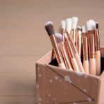 organizer with professional makeup brushes on wood 2026 03 18 16 20 45 utc
