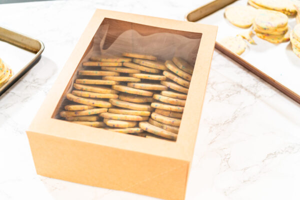 packing sprinkle adorned sugar cookies into boxes 2026 01 08 02 10 43 utc (1)