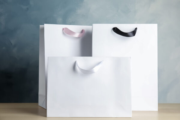 paper shopping bags on table against color backgro 2026 03 27 01 53 22 utc