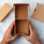 parcel cardboard box in a man hands on a gray tabl 2026 03 24 00 07 03 utc