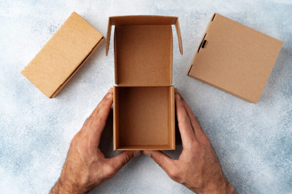 parcel cardboard box in a man hands on a gray tabl 2026 03 24 00 07 03 utc